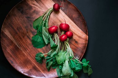 vegetables background beautiful radish with herbs on a black background