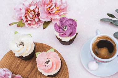 wedding cupcakes on a pink background a cup of coffee 