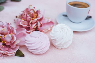 two white and pink marshmallows on a beautiful pink background with a cup of coffee Homemade berry Marshmallows