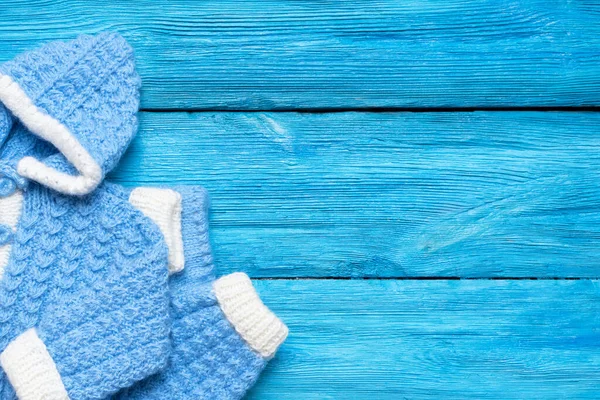 Children Warm Knitted Clothes Blue Wooden Table Background — Stock Photo, Image