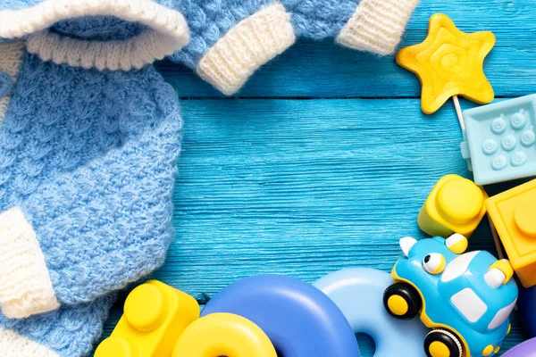 Bayi Hangat Pakaian Dan Anak Anak Mainan Atas Biru Meja — Stok Foto