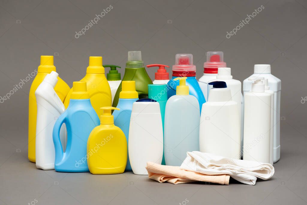 Detergent bottles on gray background.