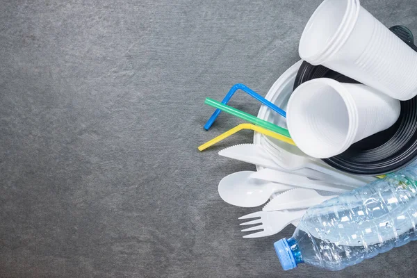 A plastic dishes on the table flat lay background with copy space.