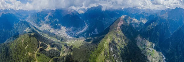 Panorama of mountains in Georgia . Aerial shot above the clouds. Svaneti.