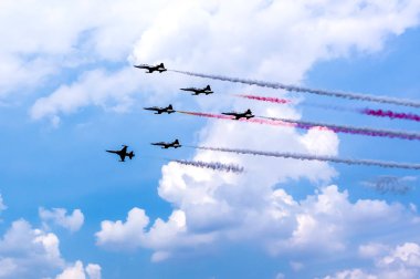 Akrobatik uçuş gerçekleştiren ve duman arkasında iz bırakarak ordu uçak silueti