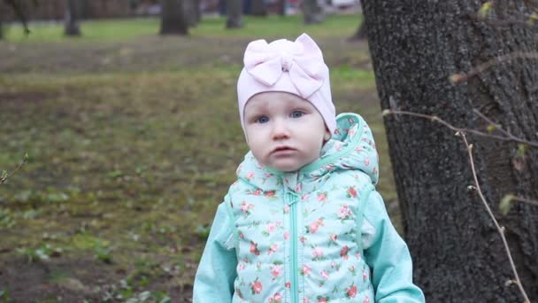 Портрет Маленькая Девочка Шляпе Куртке Весной Природе Смотрит Камеру — стоковое видео