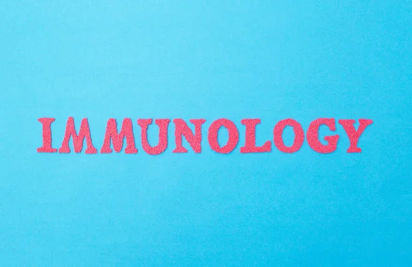 The word immunology in red letters on a blue background. The concept of the section of medicine dealing with the study of human immunity