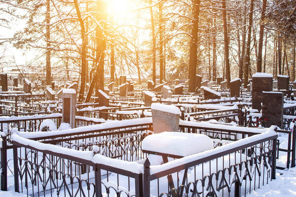 Winter time. Cemetery with monuments under the snow, background, graveyard