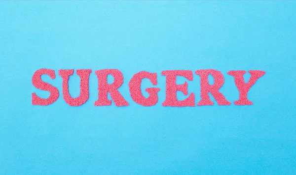 The word surgery made of red letters on a blue background. The concept of the section of medicine dealing with surgical operations in various fields of medicine, abdominal — Stock Photo, Image