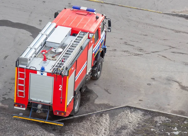 Caminhão de bombeiros vermelho com luzes de emergência, salvando pessoas, ameaça a l — Fotografia de Stock
