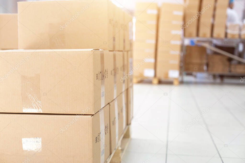 Warehouse with its own production. A pile of cardboard boxes on a pallet. The concept of shipping and delivery of goods from a warehouse, logistics, industry