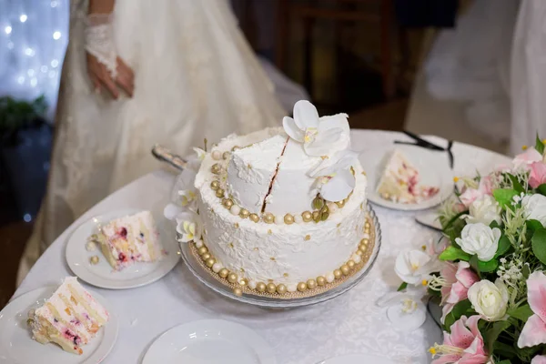 Bride and groom cutting a cake at a wedding