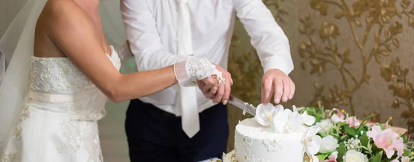 Bride and groom cutting a cake at a wedding