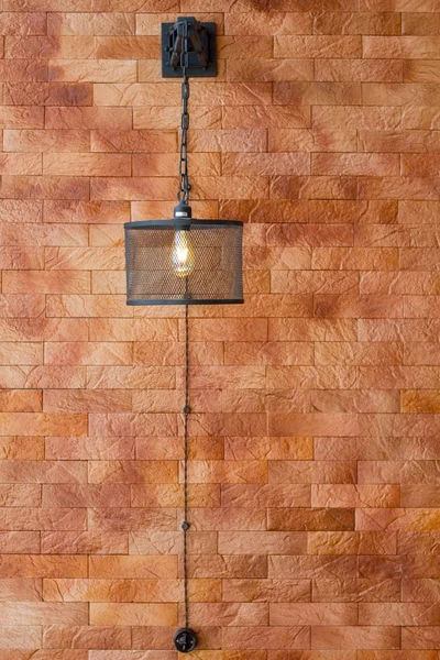 Wall sconce fixture against brown wall background