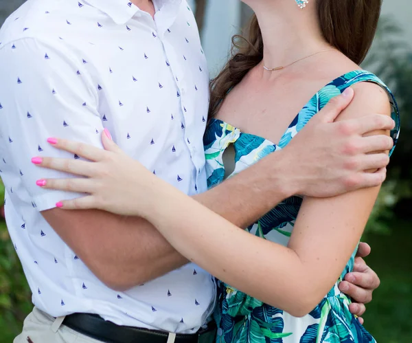 Young couple strolling in summer in the park