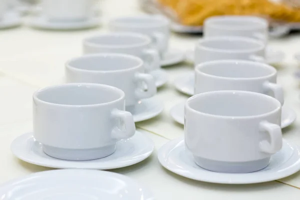 White cups on a coffee break table