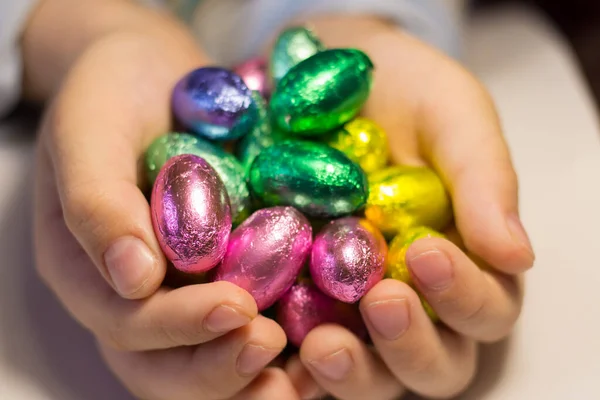 Chocolate eggs in the hands of a child