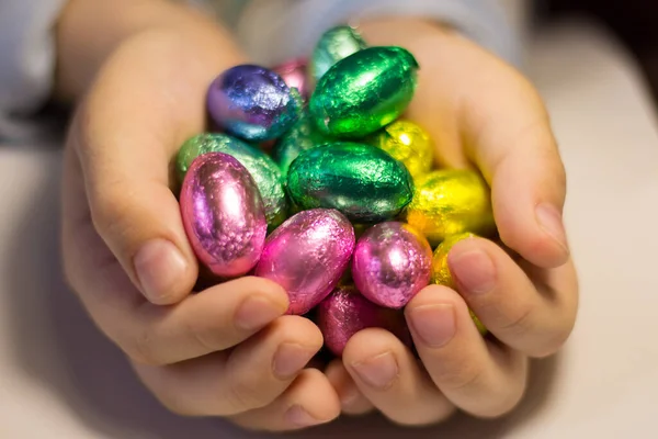 Chocolate eggs in the hands of a child