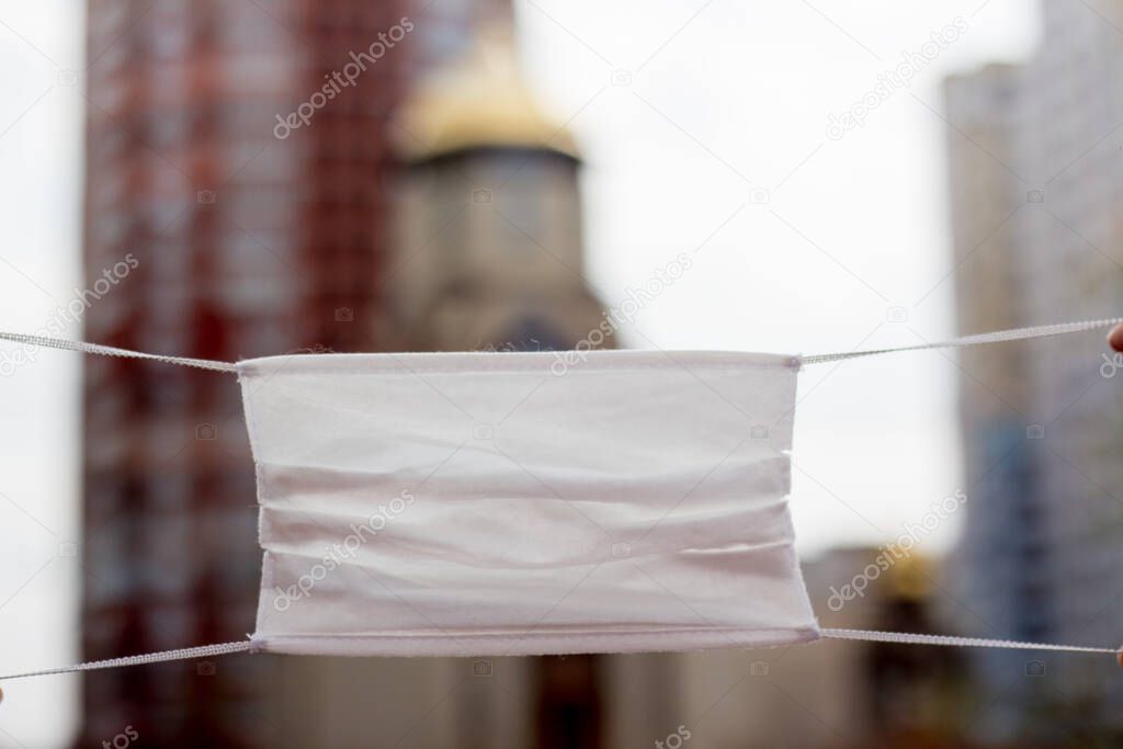 Medical mask on the background of the church building