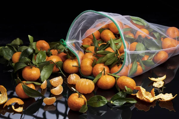 Reusable mesh bag with fruit tangerines. Zero waste instead of plastic bags.
