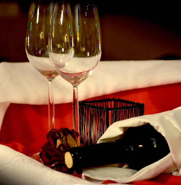 Wine glasses and a bottle in white serviette. Restaurant table setting. Romantic evening. Valentine's day concept.
