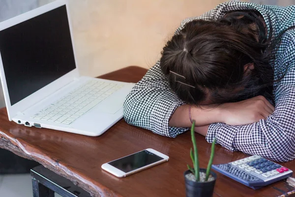 Exhausted women sleeping at workplace after hard working day