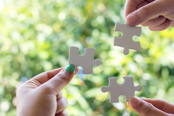 Close up of three hands holding jigsaw, — Stock Photo, Image