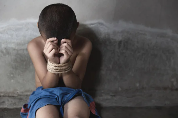 Victim child tied up with rope in emotional stress and pain. Sto — Stock Photo, Image