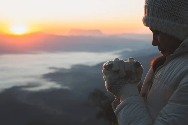 A women is praying to God on the mountain. Praying hands with fa — 스톡 사진