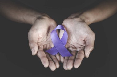 Woman Hand Holding Purple Ribbon, Domestic Violence Awareness Mo
