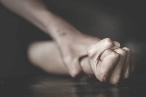 Close up man\'s hand holding a woman hand for rape and sexual abuse concept.