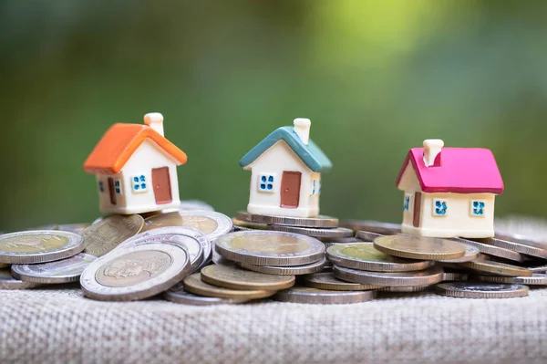 テーブルの上の家とコイン 不動産投資と住宅ローン金融の概念 — ストック写真