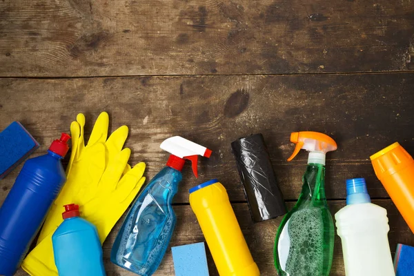 Cleaning products on wooden background. House cleaning concept. Top view. From above. Copy space.