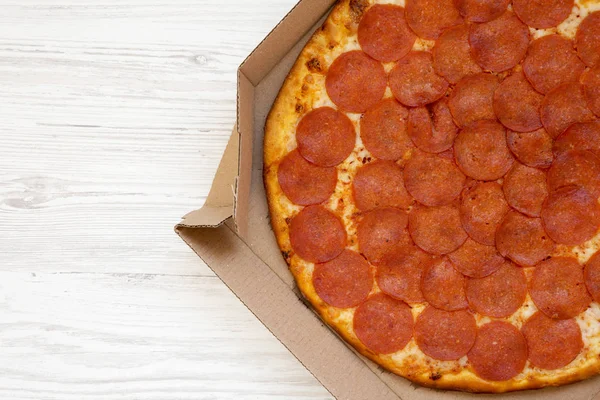 하얀 나무 배경 위에 놓인 상자 안에 있는 맛있는 페퍼로니 피자,위에 있는 것은 — 스톡 사진