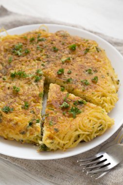 Beyaz tabakta ev yapımı spagetti omleti, düşük açılı. CI