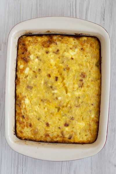 Homemade Cheesy Amish Breakfast Casserole on a white wooden back
