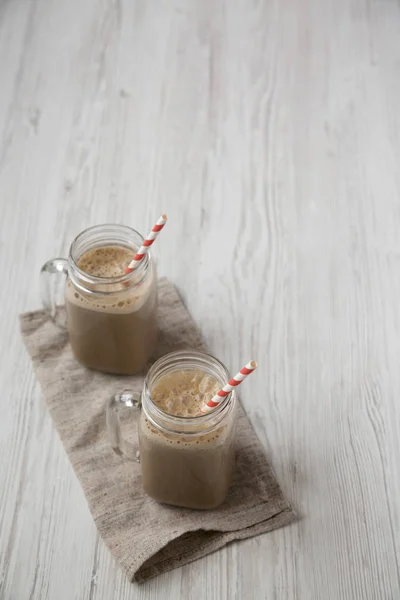 Kaca guci cangkir diisi dengan kopi, oat dan pisang smoothie pada — Stok Foto
