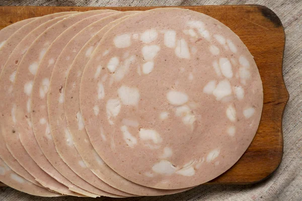 Sliced Mortadella Bologna Meat on a rustic wooden board, top vie — Stock Photo, Image