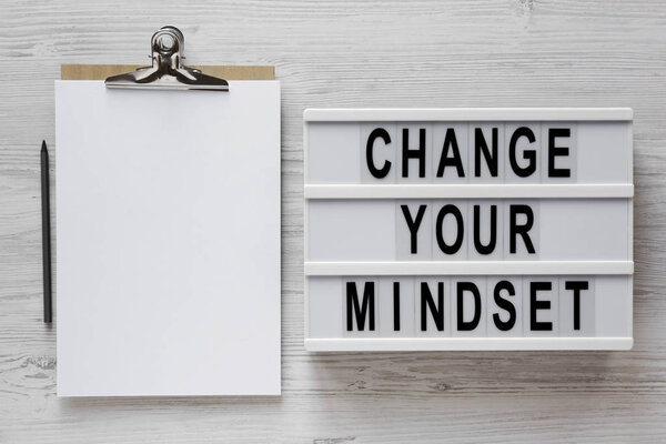 'Change your mindset' words on a modern board, clipboard with bl