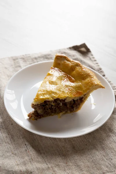 Slice of Homemade Canadian Tourtiere Meat Pie on a white plate , — Stock Photo, Image
