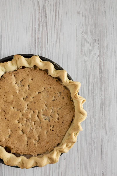 Home-baked Chocolate Walnut Derby Pie on a white wooden surface, — Stock Photo, Image