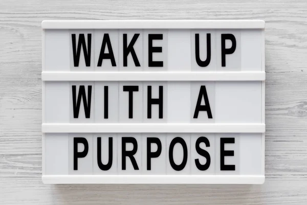 'Wake up with a purpose' words on a modern board on a white wood — Stock Photo, Image