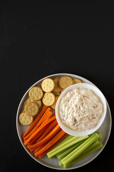 Homemade Pimento Cheese Dip with carrots, celery and crackers ov
