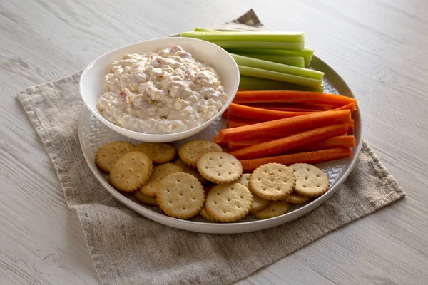 Homemade Pimento Cheese Dip with carrots, celery and crackers, s