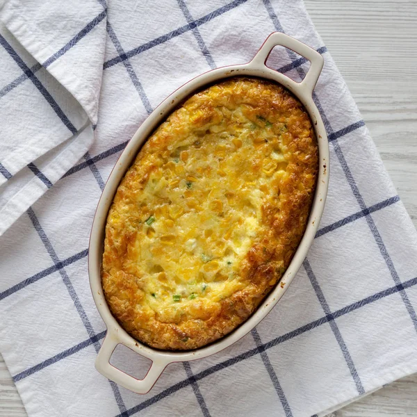 Homemade Cheddar Corn Pudding Casserole, top view. Flat lay, top