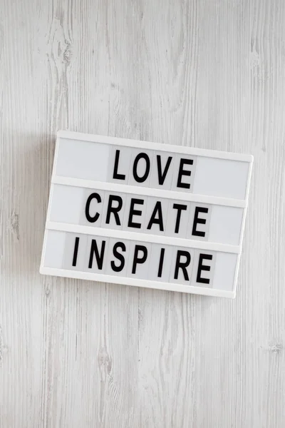 'Love create inspire' words on a modern board on a white wooden — 스톡 사진