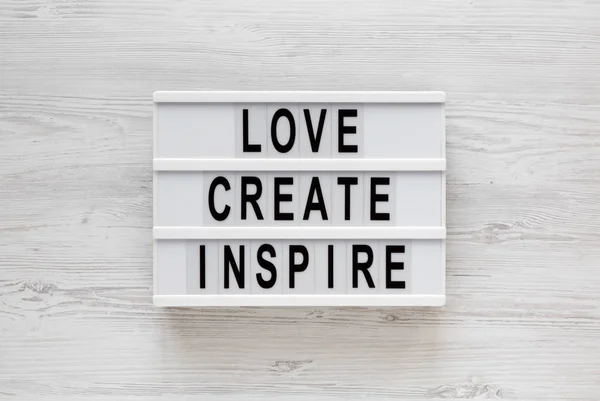 'Love create inspire' words on a modern board on a white wooden — 스톡 사진