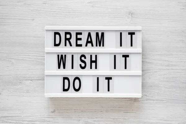 \'Dream it, wish it, do it\' words on a lightbox on a white wooden