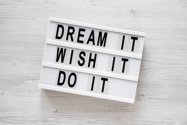 \'Dream it, wish it, do it\' words on a modern board on a white wo