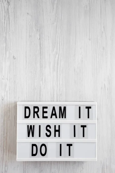 \'Dream it, wish it, do it\' words on a lightbox on a white wooden